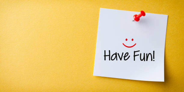 istock White Sticky Note With Have Fun And Red Push Pin On Yellow Background 1225472635