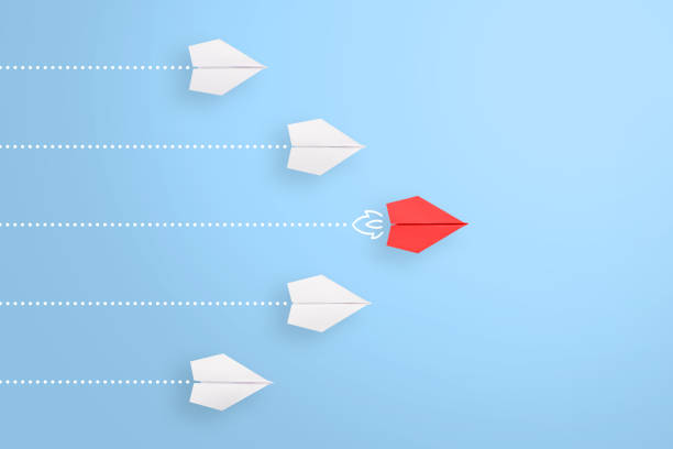 istock Leadership concepts with red paper airplane leading among white 1225472659