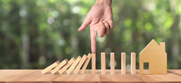 istock Hand and Domino effect stopped by unique 1225472710