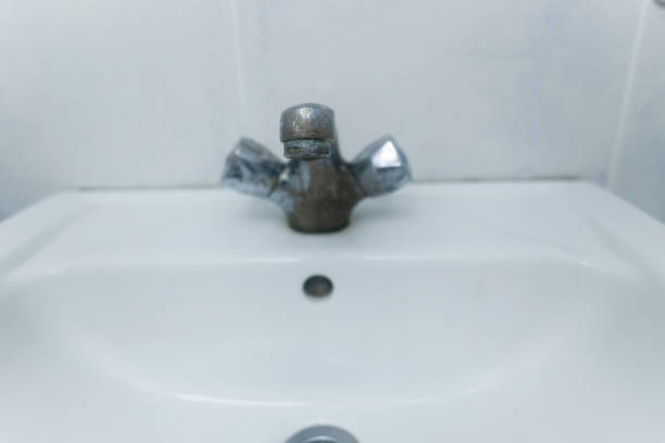 istock A rusty and chalky tap. Lime water effect. Close up. 1225478175