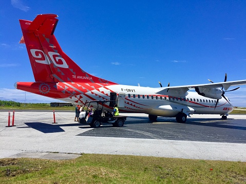 Bora Bora Island, French Polynesia-November 10, 2017: An ATR regional whirlpool plane parked in the apron of Bora Bora Island Airport, waiting the pessenger to get on board.