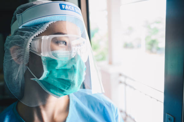 istock Nurse having tired from work while wearing PPE suit for protect coronavirus disease. 1225481427
