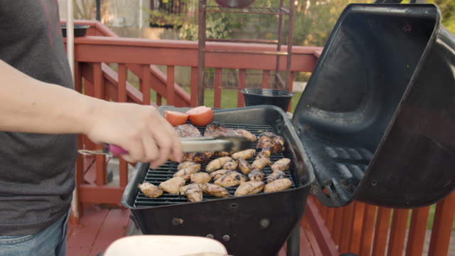 a man barbecue in his back yard