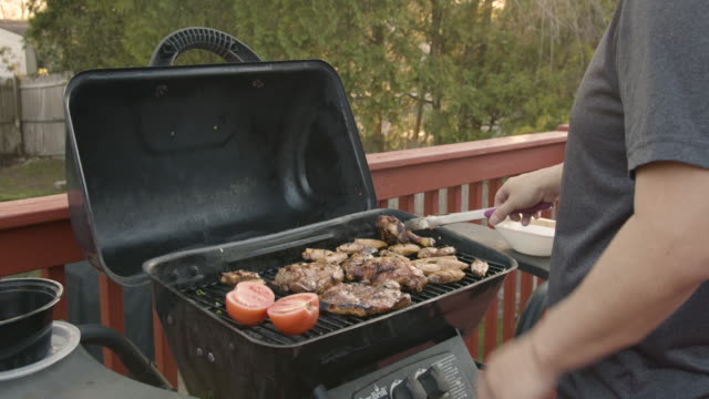 a man barbecue in his back yard