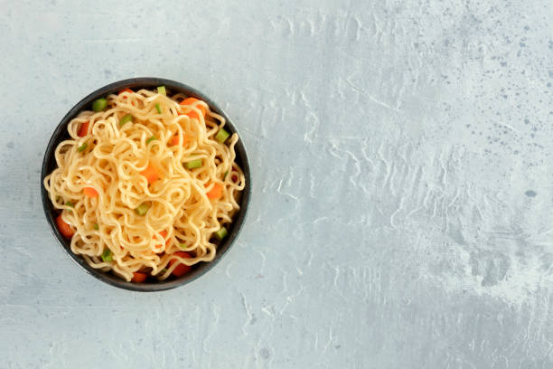 istock Instant noodles with carrot and scallions, vegetable soba bowl, overhead shot with copyspace 1225488564