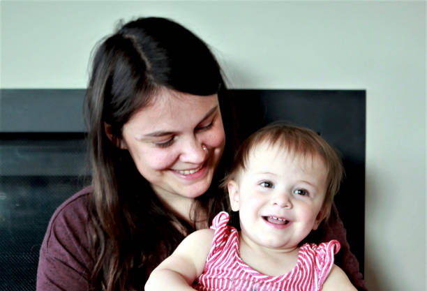 istock mom sitting with baby on lap 1225491187