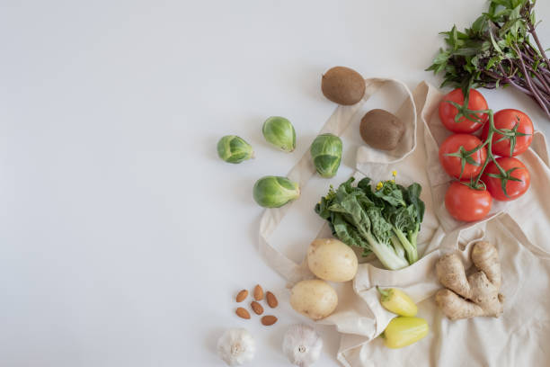 istock Cotton eco tote bag with fresh vegetables on flat lay white background .plastic free for groceries product shopping and delivery. zero waste lifestyle. healthy food and vegan diet. 1225492803