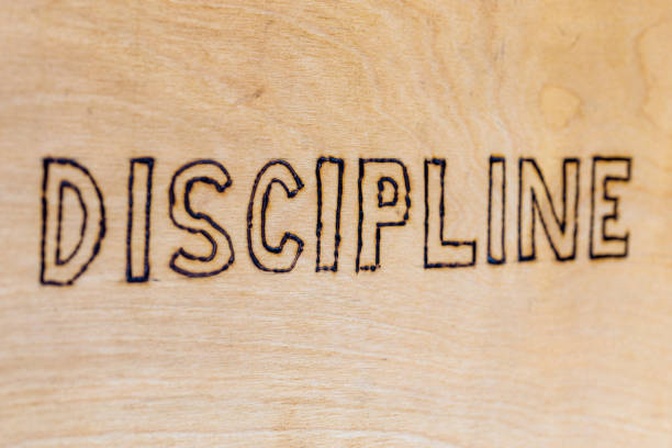 istock the word discipline burnt on white flat wooden surface - directly above normal view 1225495908