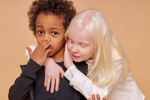 istock tender, sensitive albino girl hug african boy 1225497600