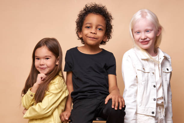 istock diverse smiling positive children posing at camera 1225497715