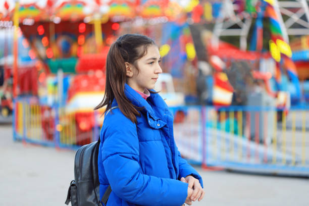 istock Girl having fun in amusement park 1225498677