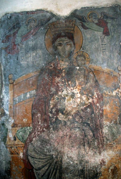 Panagia Katholiki church. Frescos inside the church. Afandou, Rhodes, Greece Located near the beach of Afandou and Afandou village. The church is of great historical, archaeological and religious interest. According to tradition, a temple (3rd century) dedicated to goddess Dimitra used to be at the same location where the church stands today. The temple was destroyed in the 6th century AD and with the materials from the ancient temple three-aisled Christian basilica church was built, which was also destroyed by an unknown cause in the 8th A.D. century but was rebuilt. The new church was built on the ruins of an early Christian basilica and the Middle Byzantine church with neat blocks and Gothic arches and occupies only part of the middle aisle of the sanctuary’s oldest temple. It’s decorated with frescoes from the 14th and 16th century A.D. This new church, which survives to this day, is dedicated to the Virgin Mary. The icon of the Virgin Mary for security reasons is kept in the church museum in Afandou, but three times a year is transferred back to the church, accompanied by priests and the people of the city. On the eve of the Assumption (August 14th ), the procession starts from the church in the town square. As soon as the icon is placed in the church the Divine Liturgy and praise begins, followed by a festival with the participation of believers from all over the island. The icon is also transferred to the church for Novena and Monday after Easter. afandou stock pictures, royalty-free photos & images