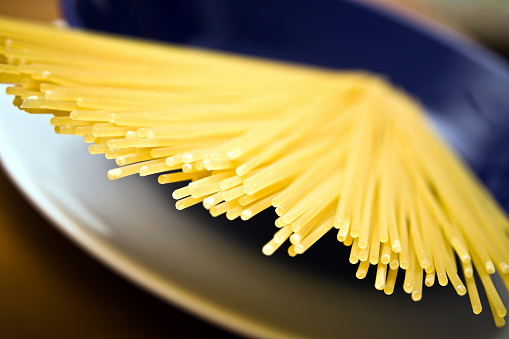 The Raw spaghetti italian pasta.Uncooked spaghetti background with place for text.