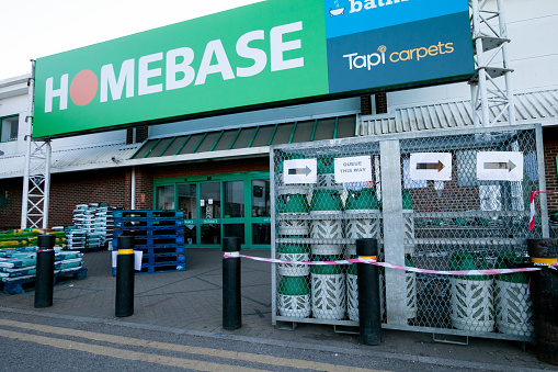 Outside Homebase shopping store in Otford (Riverside Retail Park) near Sevenoaks, signs guide customers how to queue during the Covid-19 crisis. Homebase is a home improvement retailer.