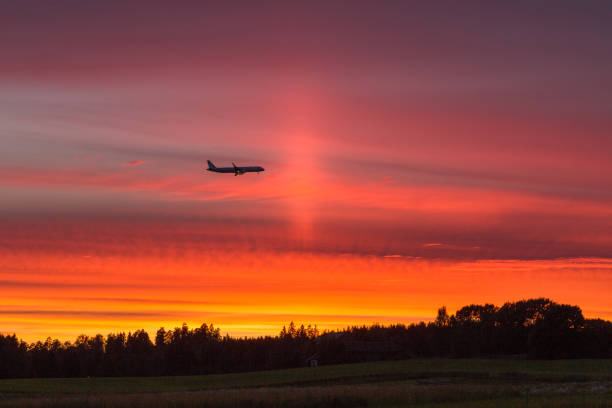 Airplane flying against the beautiful sunset