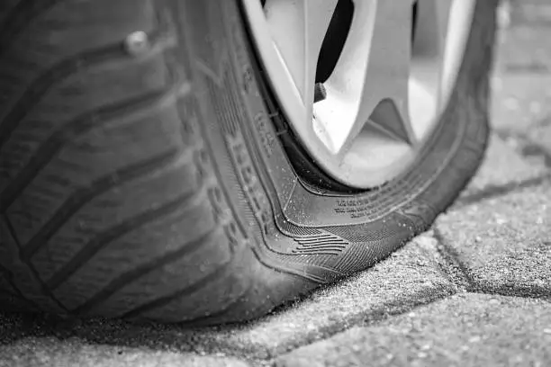 Photo of Flat tire on the roadside - driven over a nail