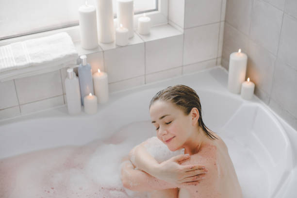 istock A young beautiful woman uses a body srab in a bath. 1225504206