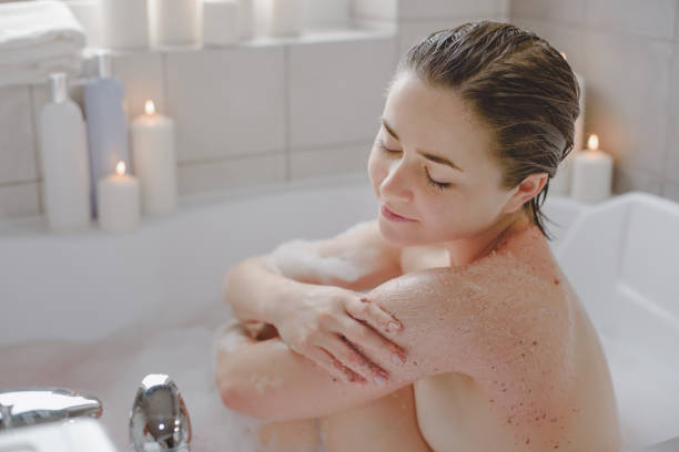 istock A young beautiful woman uses a body srab in a bath. 1225504207