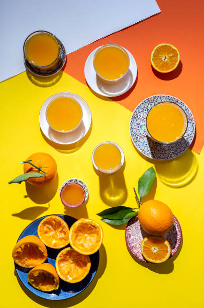istock orange juice from above on colored backgrounds. 1225504563