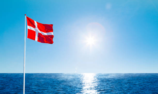 Danish flag in the wind against a blue sky