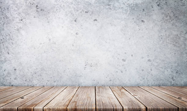 istock Wooden table in front of stone wall 1225505766