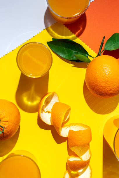 istock orange juice from above on colored backgrounds. 1225506951