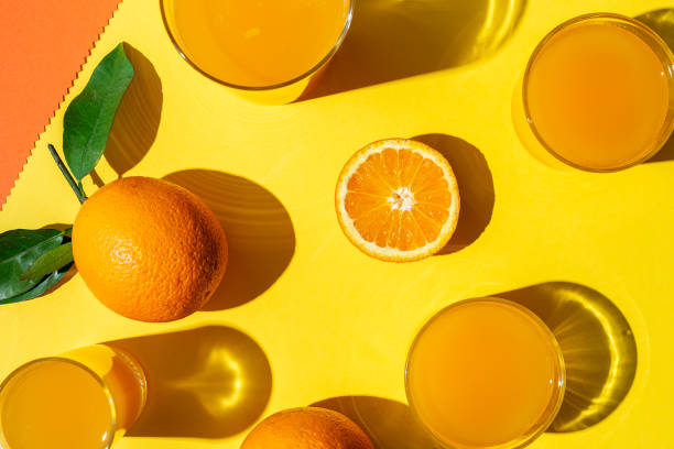 istock orange juice from above on colored backgrounds. 1225506956