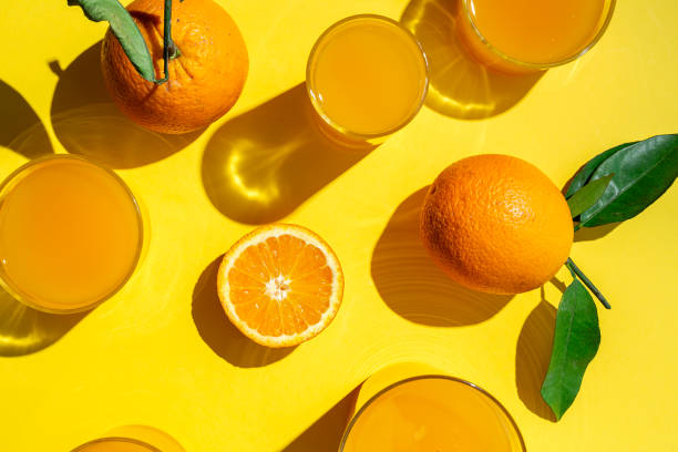 istock orange juice from above on colored backgrounds. 1225506984