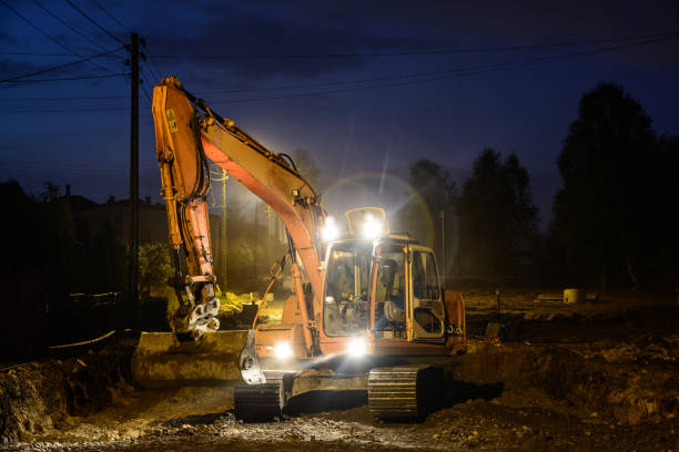istock Orange excavator digger working at night on the street 1225509777