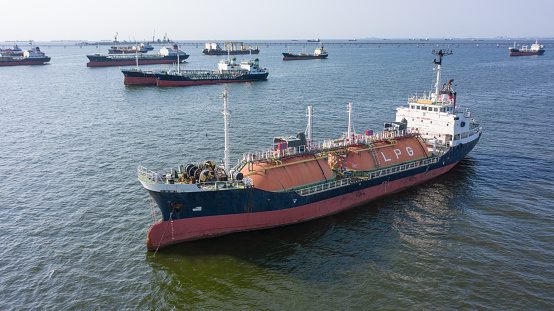 energy export and import business for transportation trade. aerial top view of the ship carrying the LPG and oil tanker in the sea port with vessel global logistics