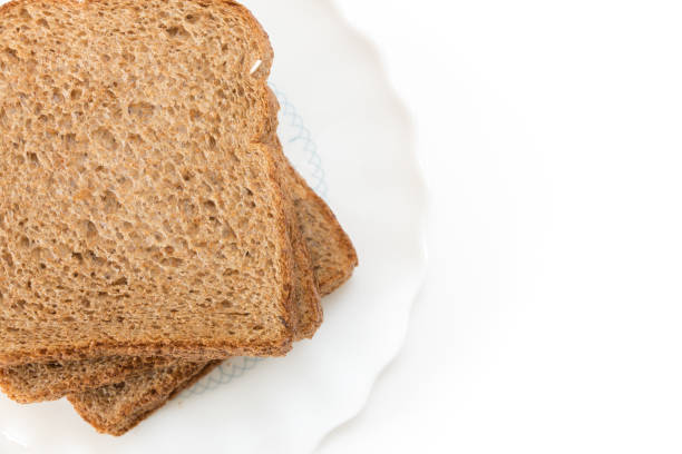 istock Whole grain sandwich bread slices on plate, on white background. 1225511050