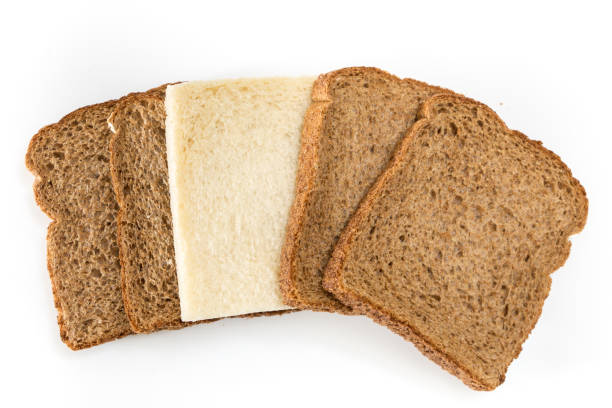 istock Whole grain sandwich bread slices with one white slice, on white background. 1225511071