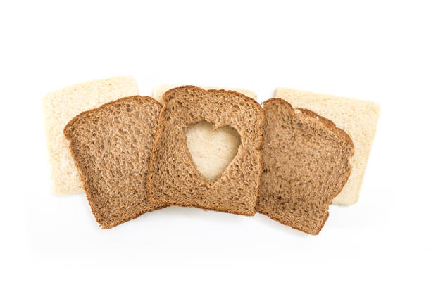 istock Sandwich bread slices with heart cut shape, on white background. 1225511592