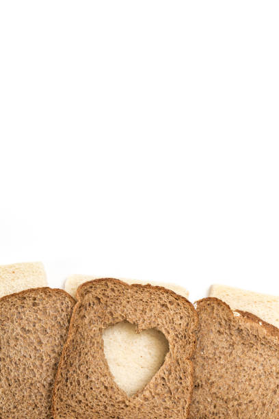 istock Sandwich bread slices with heart cut shape, on white background. 1225511596