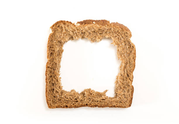 istock Whole grain sandwich bread slice with hole, on white background. 1225511597