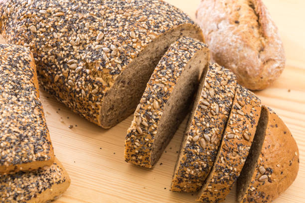 istock Whole wheat sliced bread closeup, on wooden surface. 1225511628