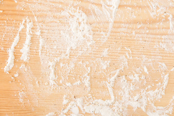 istock Messy floured wooden surface/ background. 1225511656