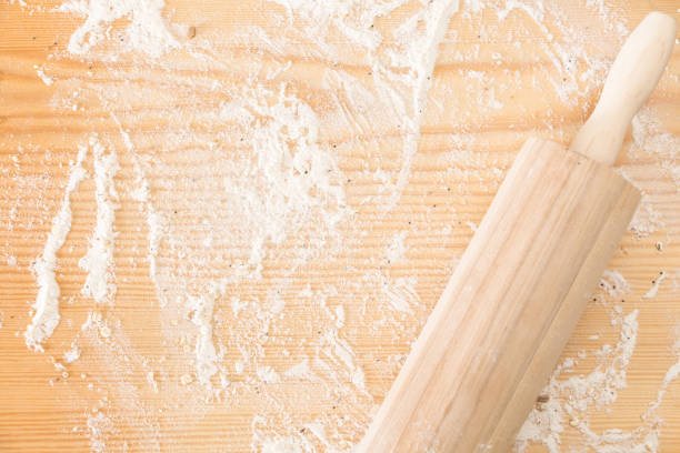 istock Messy floured wooden surface/ background and rolling pin. 1225511658