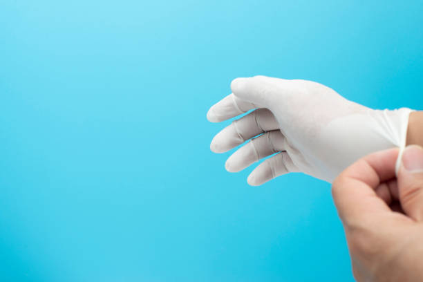 istock doctor put surgical gloves with blue background 1225512110