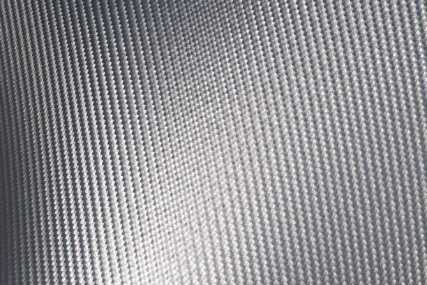 istock Close up of grey carbon fiber pattern texture surface. 1225515029
