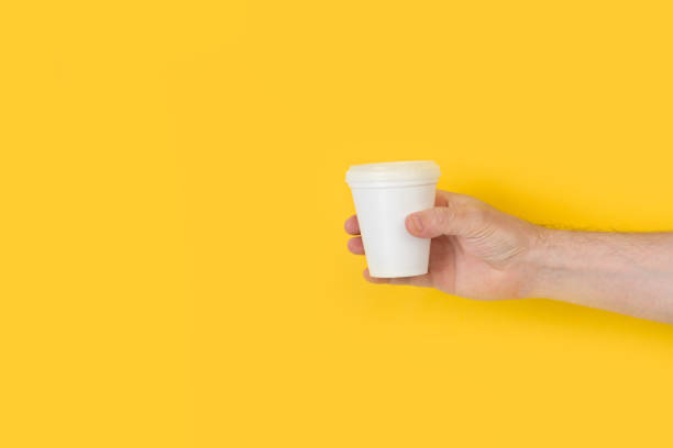 istock Man´s hand holding a disposable white cup 1225517927