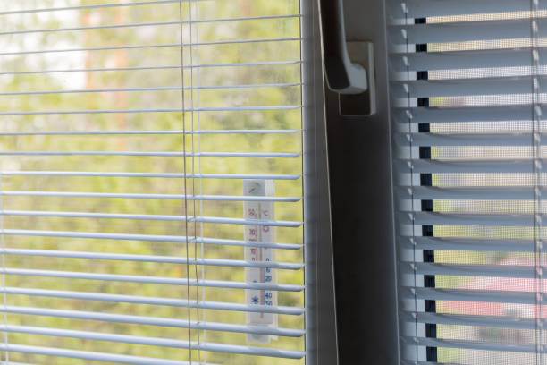 istock Fragment of the window with attached external thermometer close-up 1225518901