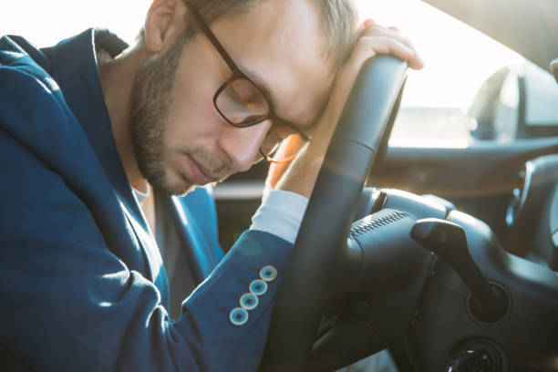 istock Close-Up Of Man Sleeping In Car 1225519116
