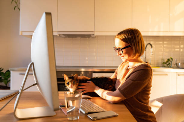 istock Side View Of Woman Holding Cat On Table At Home 1225519321