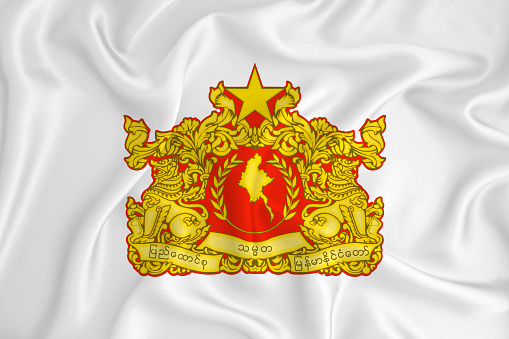 A developing white flag with the coat of arms of Myanmar. Country symbol. Illustration. Original and simple coat of arms in official colors and the right proportion