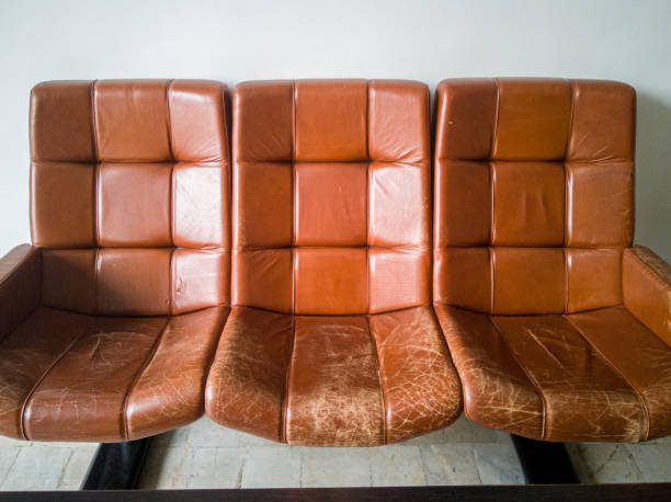 old vintage brown leather armchairs. cracked and worn skin from frequent use - armchair sofa leather brown imagens e fotografias de stock