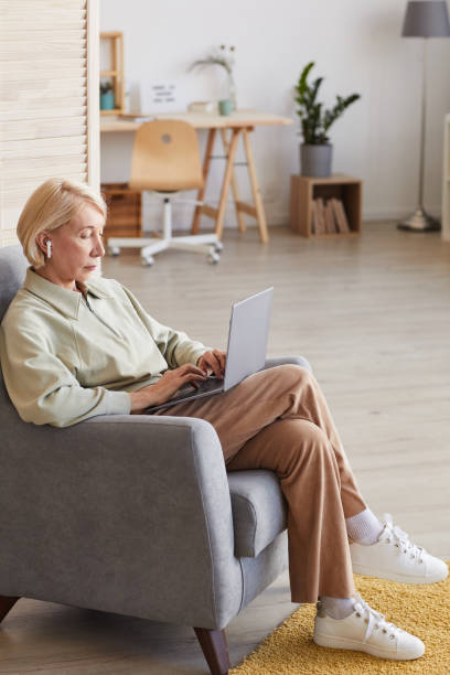 istock Woman with laptop at home 1225522096