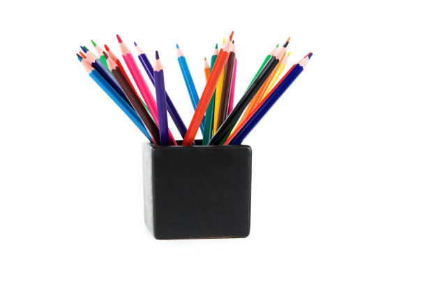 Color pencils in a glass isolated on white background. Creative background, copy space