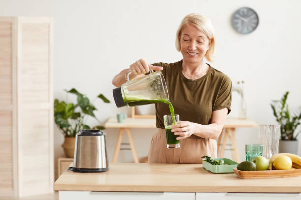 istock Woman drinking vegetable cocktail 1225522355