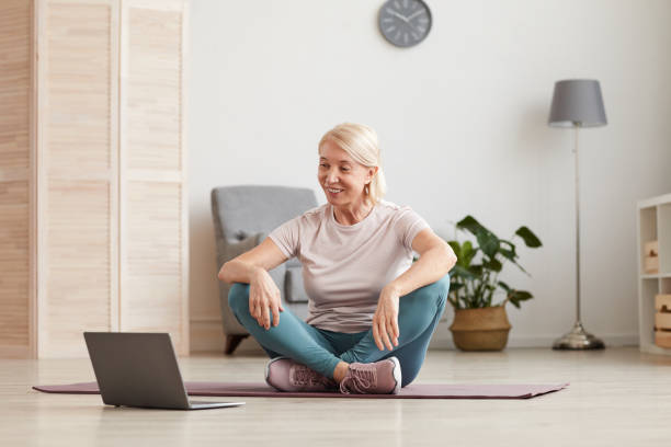 istock Woman doing yoga online 1225522901